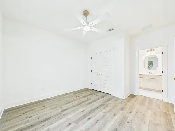 a view of a kitchen with white cabinets