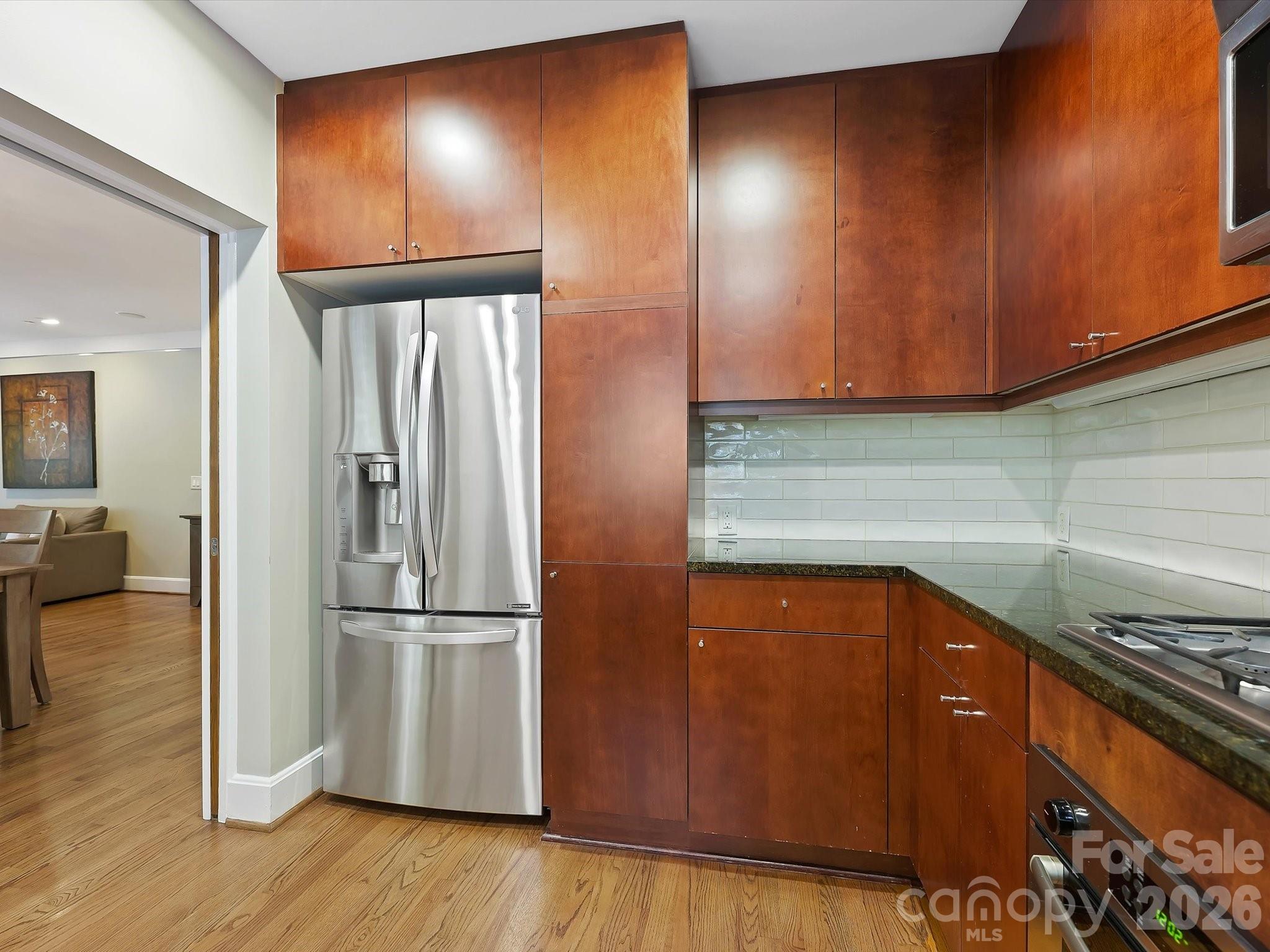 420 Queens Road Charlotte, NC 28207 - Photo 18 of 35 a kitchen with a refrigerator and a stove top oven