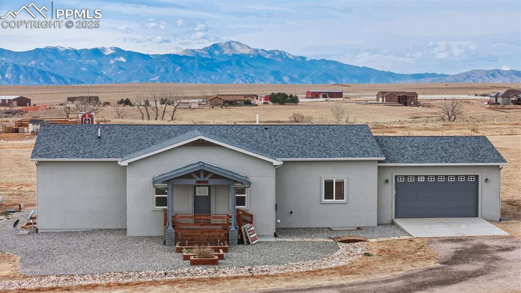 a front view of a house with a yard and parking