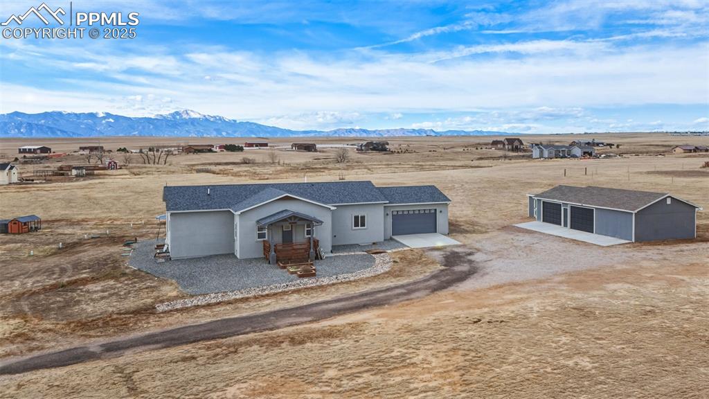 an aerial view of a house with a yard