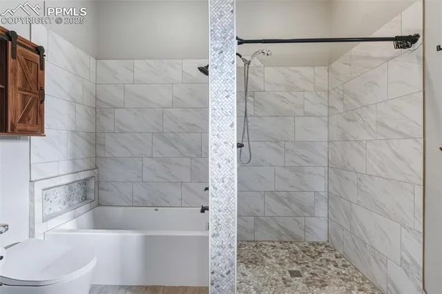 a bathroom with a bathtub and a shower