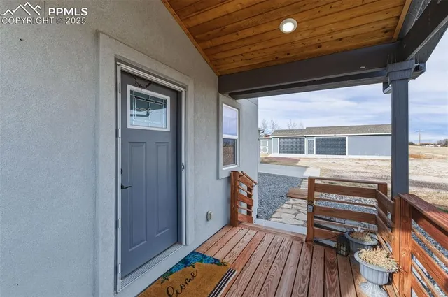 a view of front door deck and wooden floor
