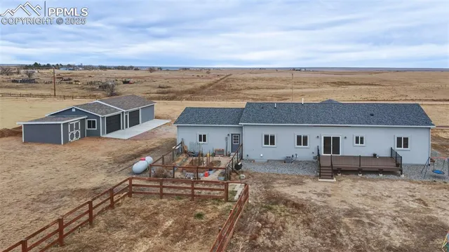 an aerial view of a house with table and chairs