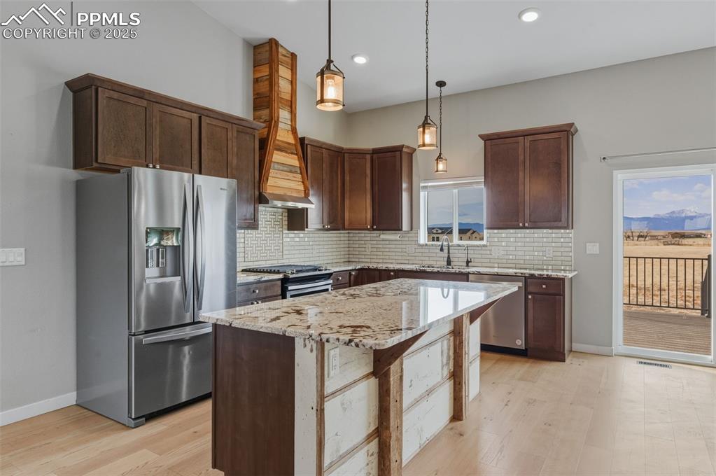 16750 Rabbit Track Trail Colorado Springs, CO 80930 - Photo 8 of 50 Kitchen stainless steel appliances, slow close cabinets and a kitchen island.