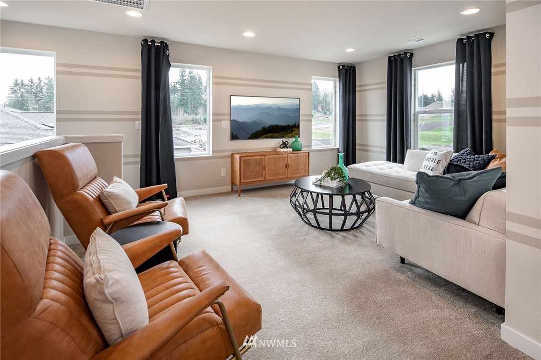 118 215th Street Southeast, Unit 8 Bothell, WA 98021 - Photo 12 of 21 a living room with furniture flat screen tv and a large window