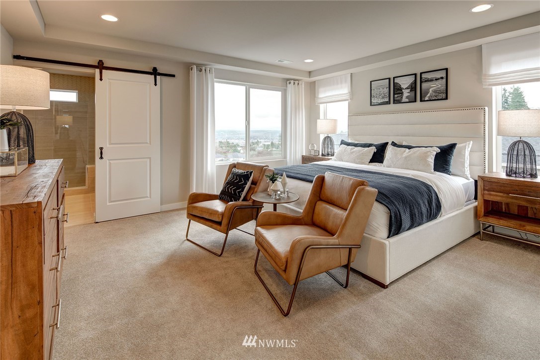 118 215th Street Southeast, Unit 8 Bothell, WA 98021 - Photo 13 of 21 a spacious bedroom with a bed and a couch
