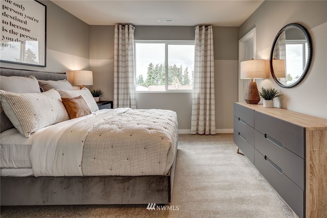 118 215th Street Southeast, Unit 8 Bothell, WA 98021 - Photo 19 of 21 a spacious bedroom with a bed and a dresser