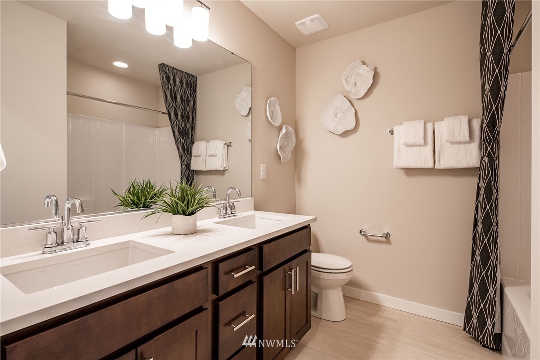 118 215th Street Southeast, Unit 8 Bothell, WA 98021 - Photo 21 of 21 a bathroom with a sink a toilet and a mirror