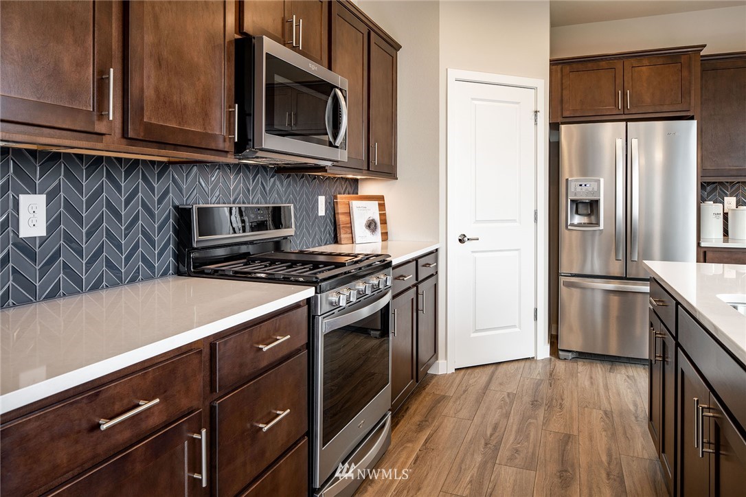 118 215th Street Southeast, Unit 8 Bothell, WA 98021 - Photo 5 of 21 a kitchen with a stove microwave and a refrigerator