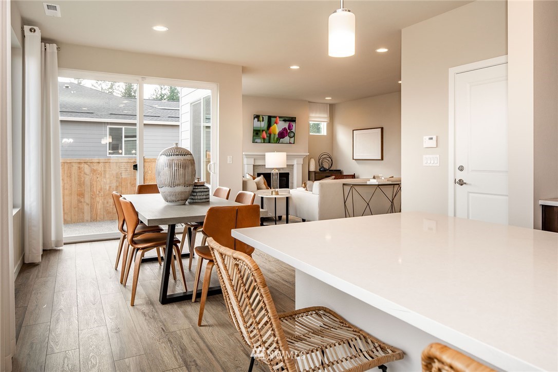 118 215th Street Southeast, Unit 8 Bothell, WA 98021 - Photo 6 of 21 a view of a dining room with furniture and wooden floor