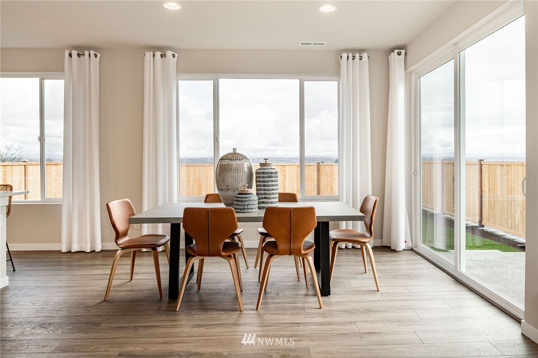 118 215th Street Southeast, Unit 8 Bothell, WA 98021 - Photo 8 of 21 a view of a dining room with furniture and wooden floor