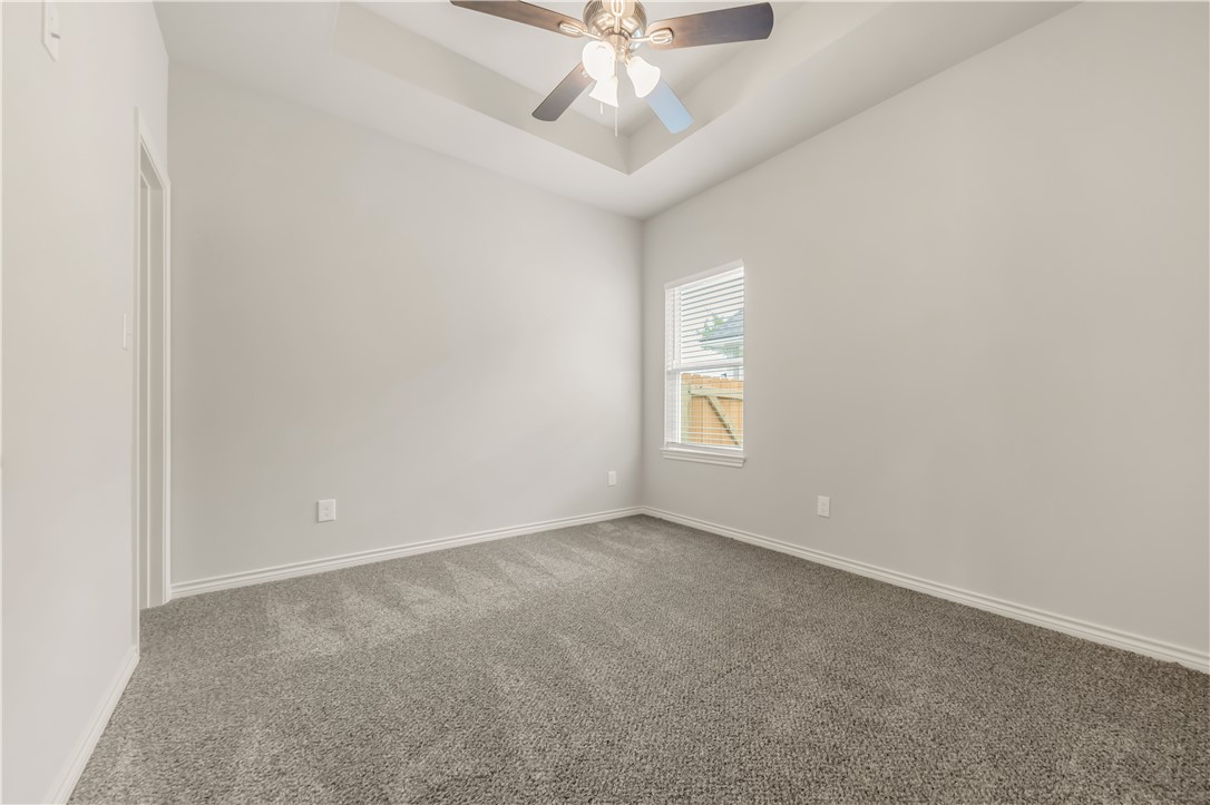 1801 Pin Oak Street Bryan, TX 77803 - Photo 12 of 17 an empty room with a window and a ceiling fan