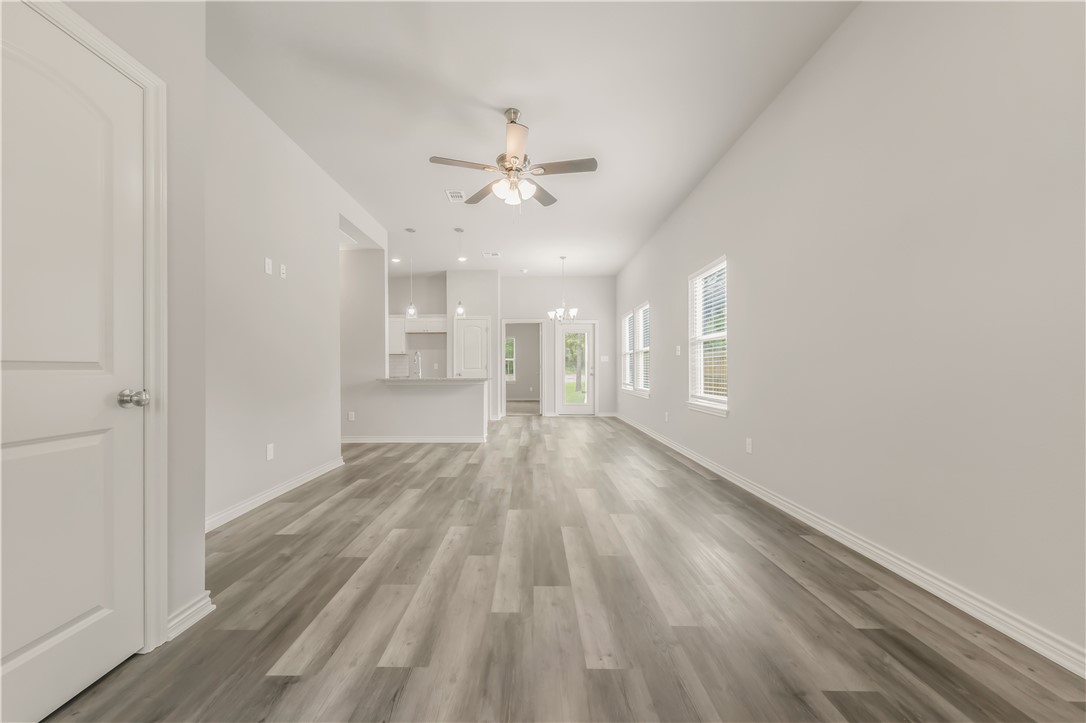 1801 Pin Oak Street Bryan, TX 77803 - Photo 2 of 17 wooden floor in an empty room with a window