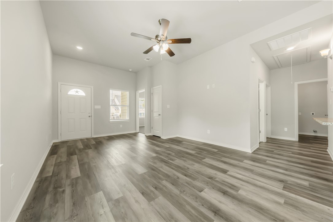 1801 Pin Oak Street Bryan, TX 77803 - Photo 4 of 17 a view of an empty room with wooden floor and a window