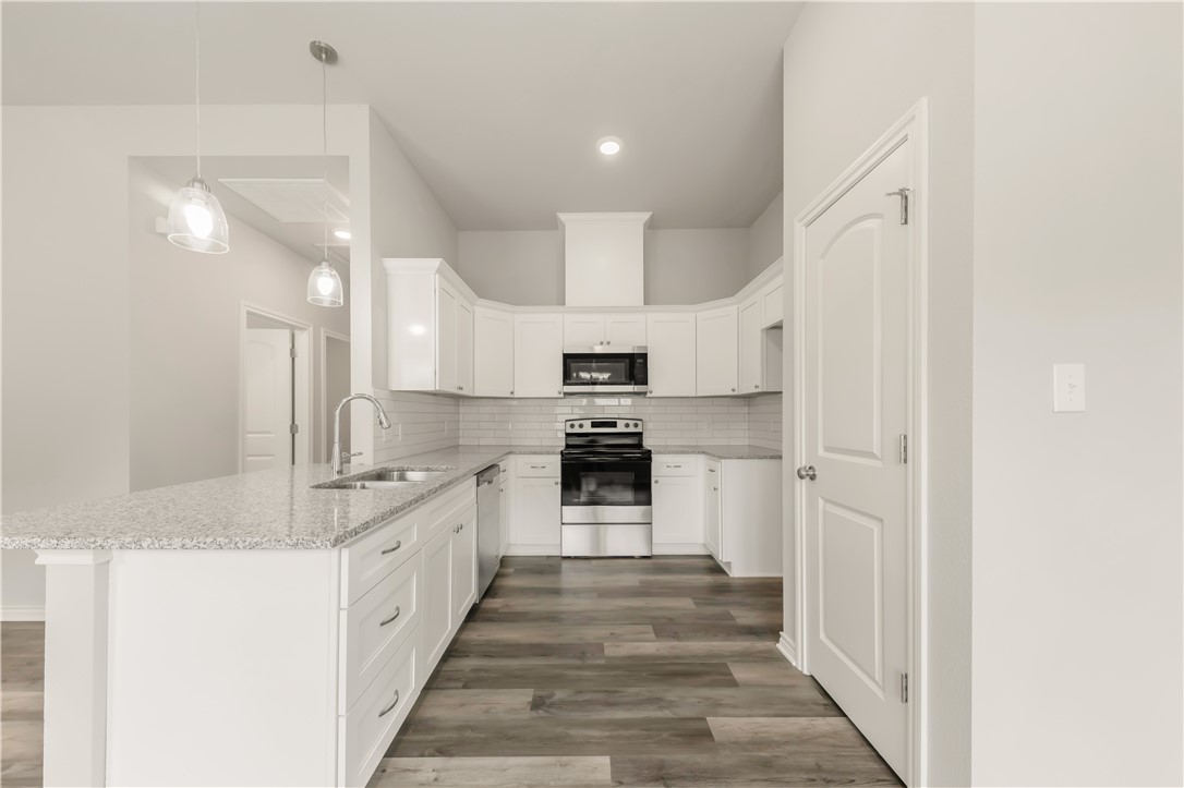 1801 Pin Oak Street Bryan, TX 77803 - Photo 7 of 17 a large kitchen with a stove and a refrigerator