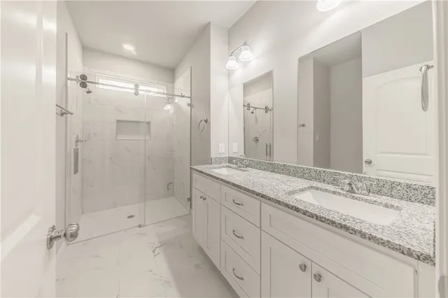 a bathroom with a granite countertop sink mirror and double