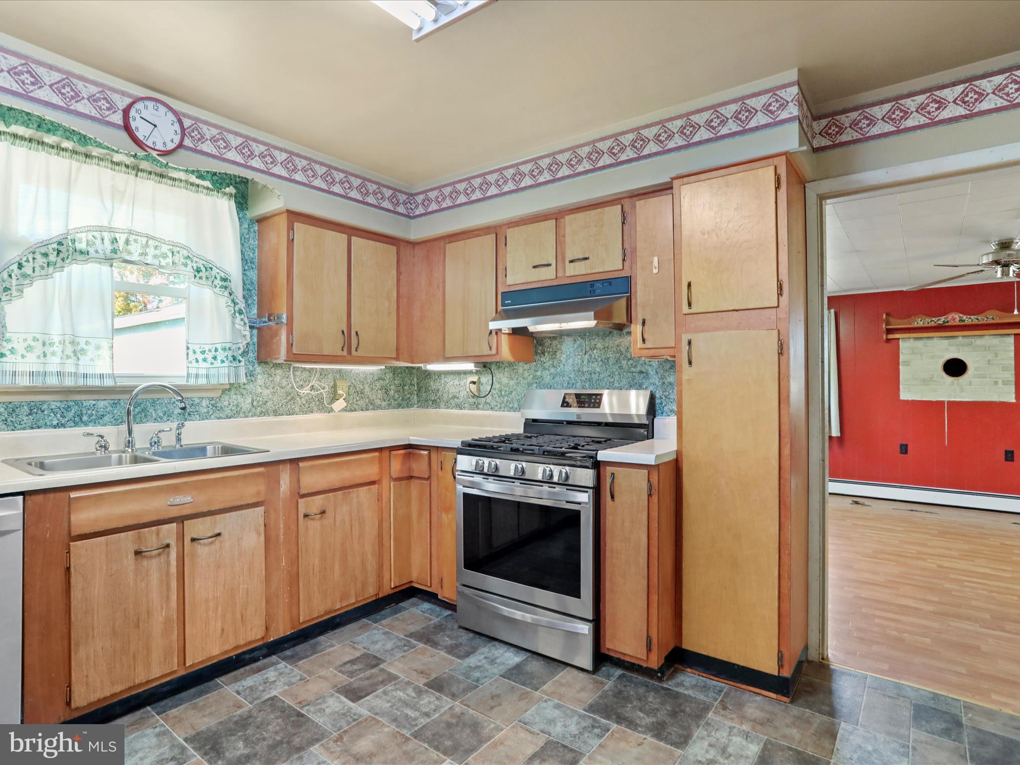 60 Grey Spring Avenue Bunker Hill, WV 25413 - Photo 11 of 35 a kitchen with stainless steel appliances granite countertop a stove a sink and a refrigerator