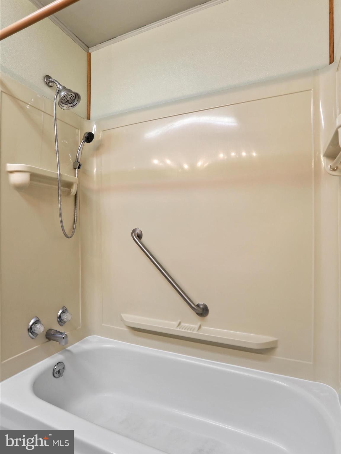 60 Grey Spring Avenue Bunker Hill, WV 25413 - Photo 14 of 35 a bathroom with a tub and a shower