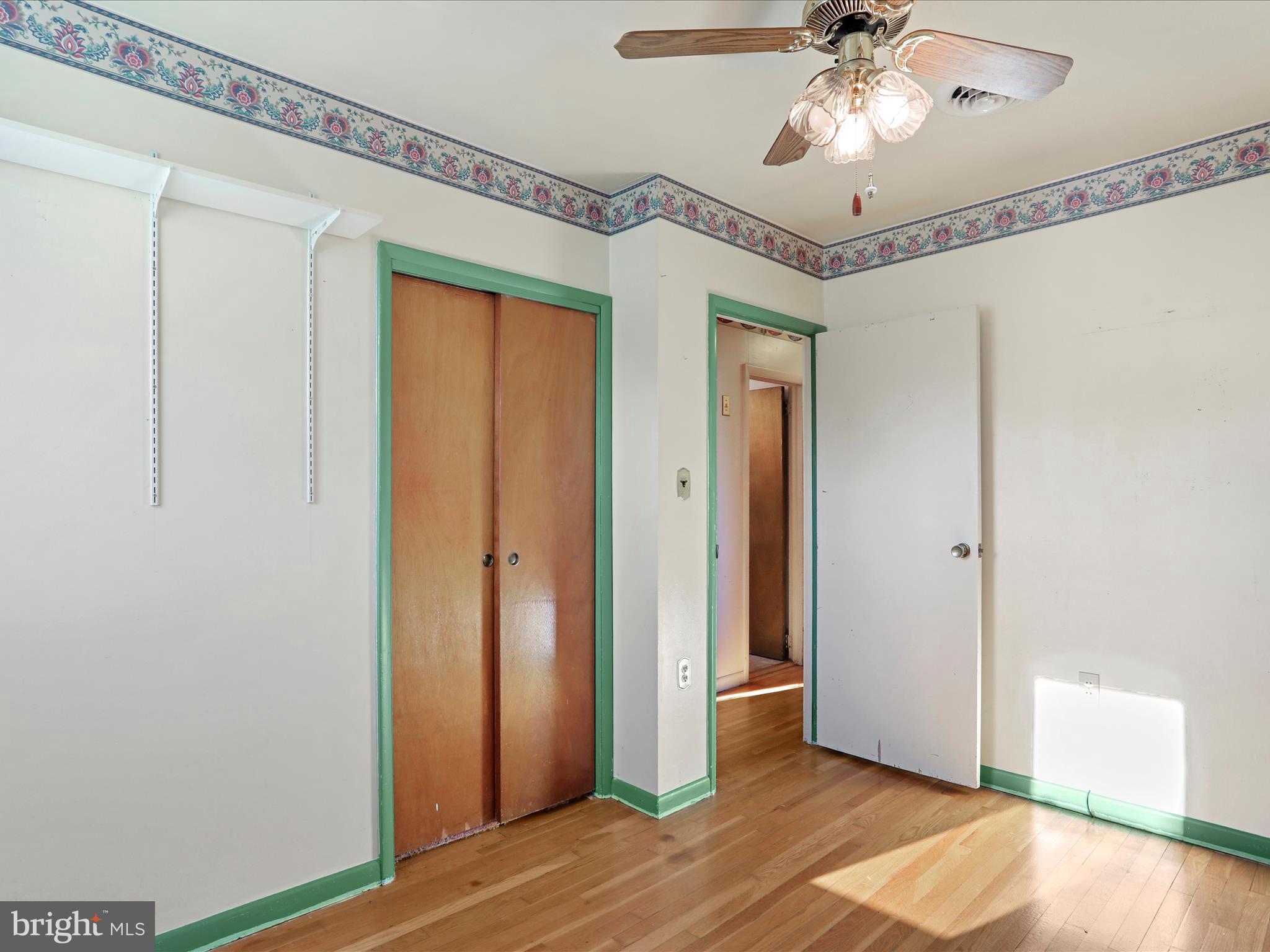 60 Grey Spring Avenue Bunker Hill, WV 25413 - Photo 17 of 35 a view of a hallway with wooden floor and chandelier fan