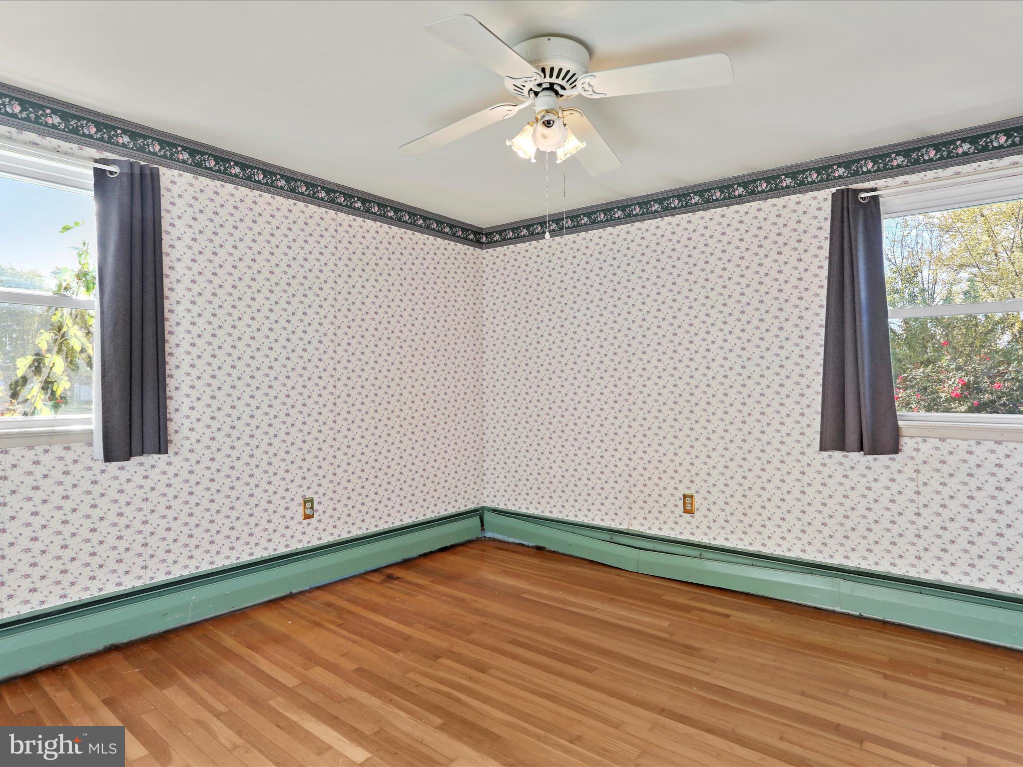 60 Grey Spring Avenue Bunker Hill, WV 25413 - Photo 21 of 35 an empty room with wooden floor and windows