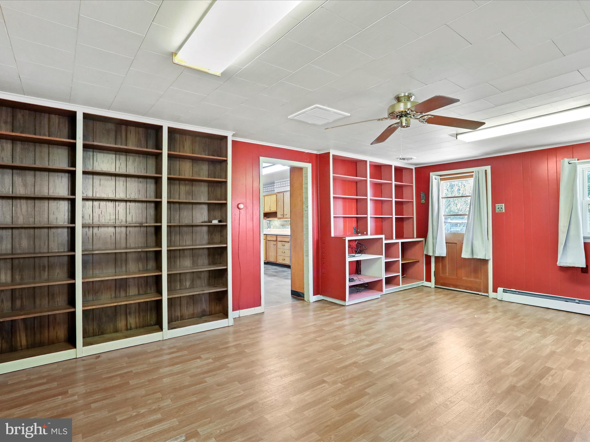 60 Grey Spring Avenue Bunker Hill, WV 25413 - Photo 22 of 35 a view of an empty room with wooden floor and a window