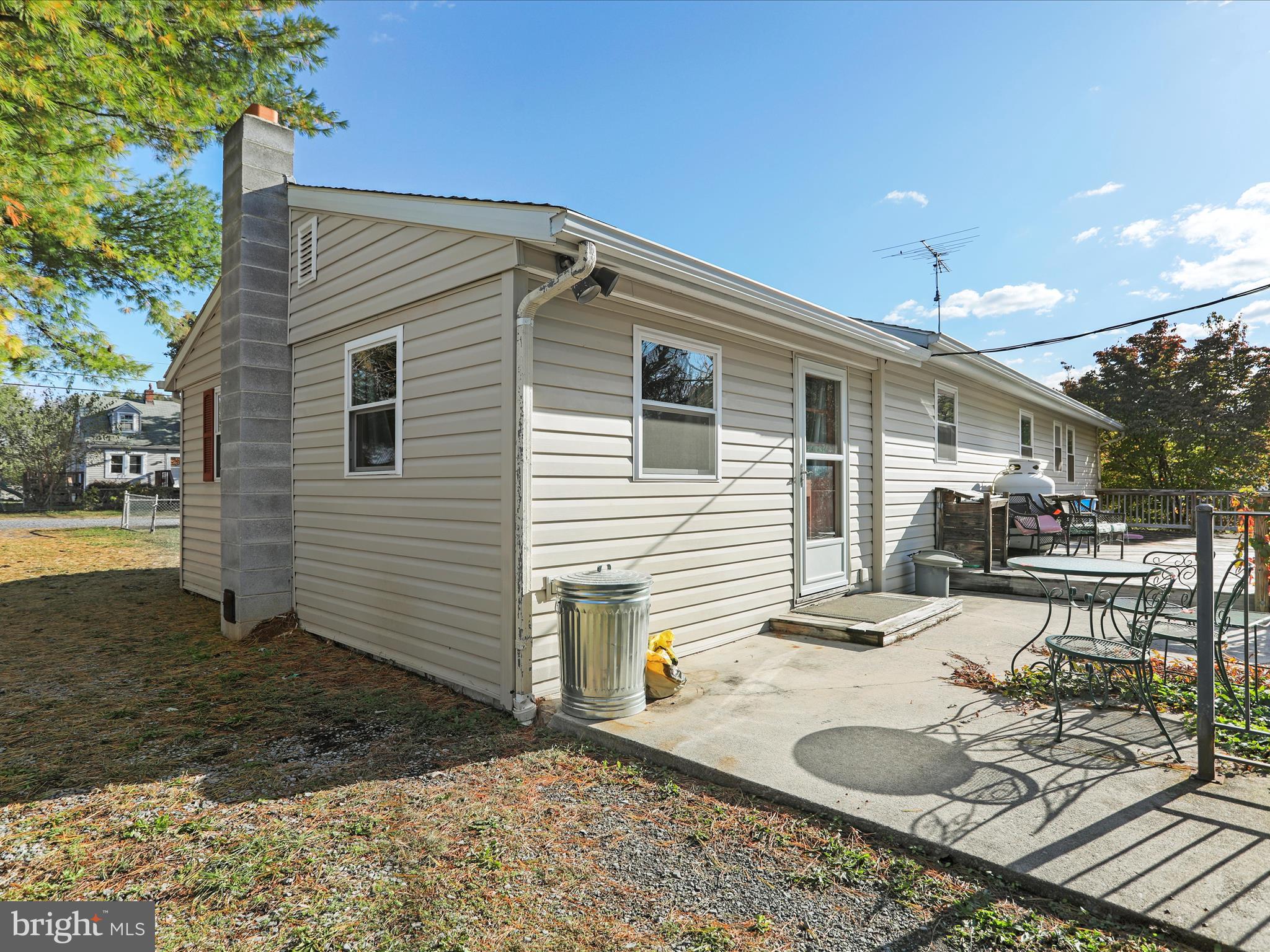 60 Grey Spring Avenue Bunker Hill, WV 25413 - Photo 26 of 35 a backyard of a house with yard and outdoor seating