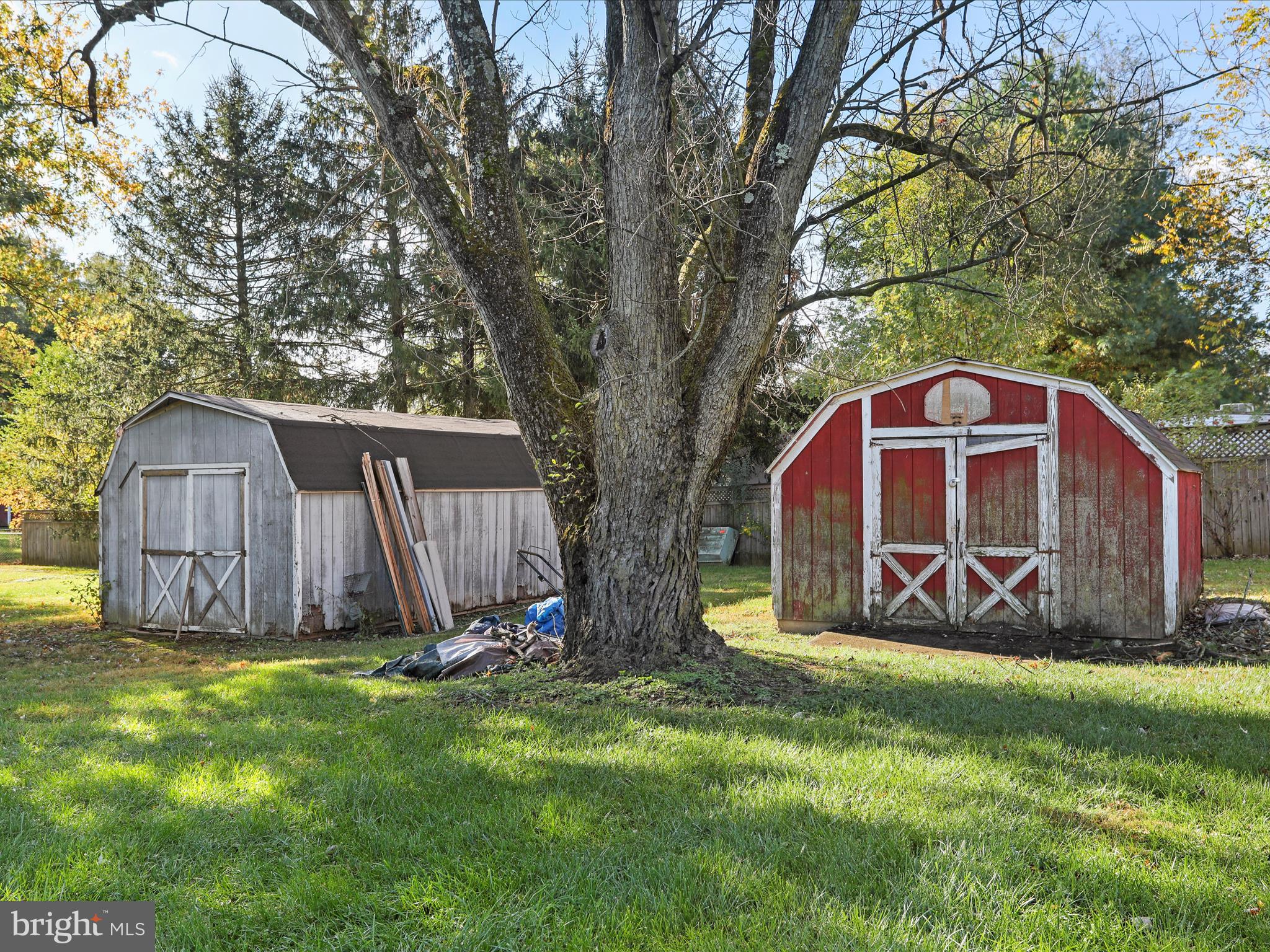 60 Grey Spring Avenue Bunker Hill, WV 25413 - Photo 30 of 35 a view of a backyard with a large tree and wooden fence