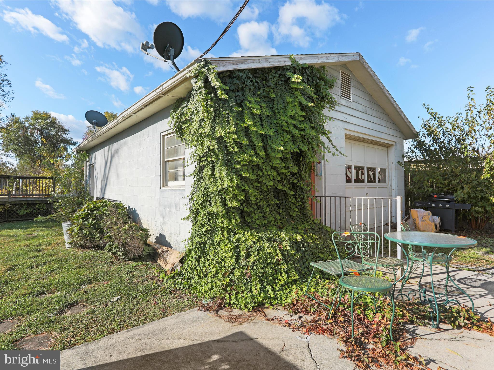 60 Grey Spring Avenue Bunker Hill, WV 25413 - Photo 35 of 35 a blue sign sitting in front of a house