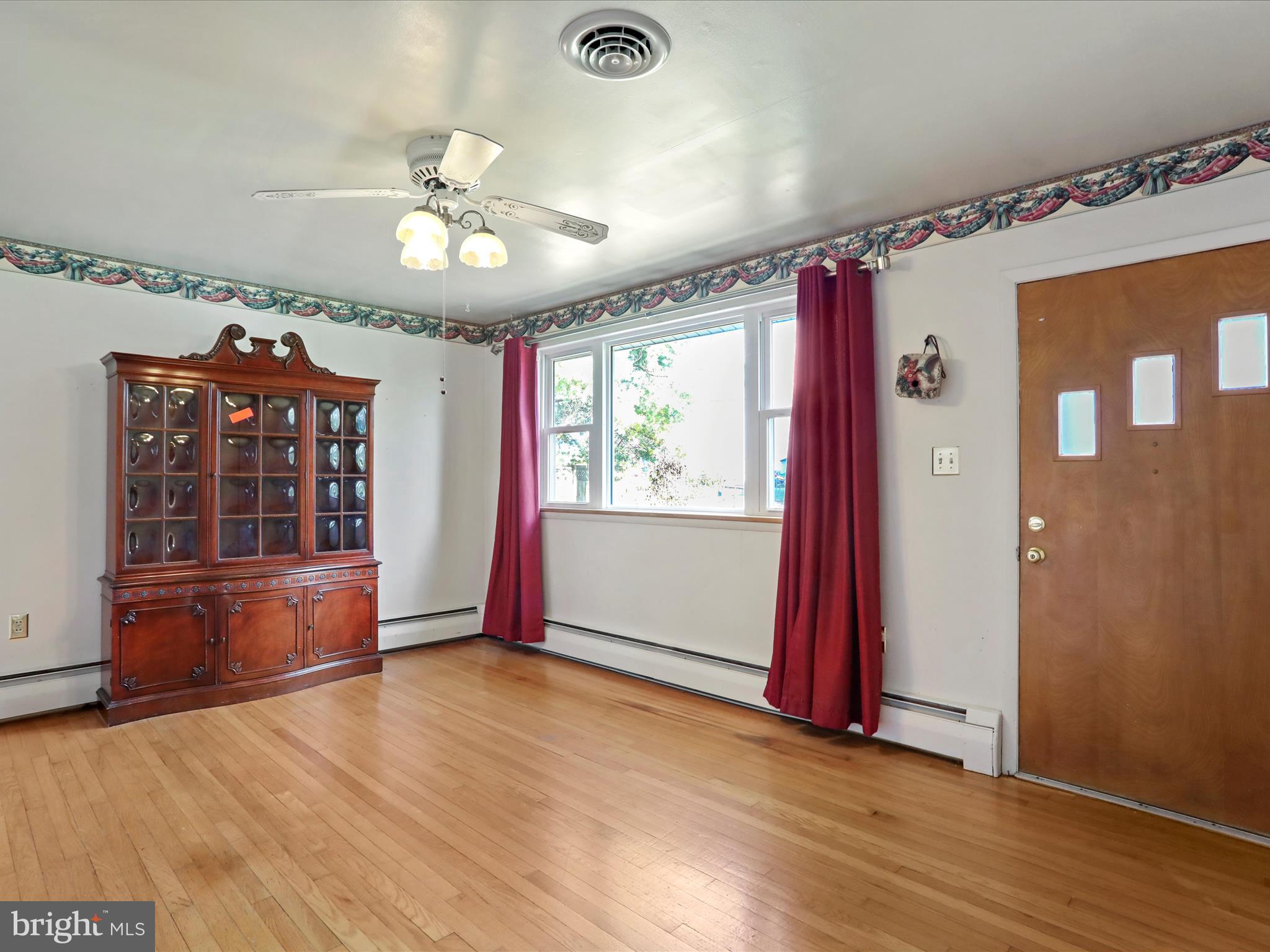 60 Grey Spring Avenue Bunker Hill, WV 25413 - Photo 5 of 35 wooden floor in an empty room with a window