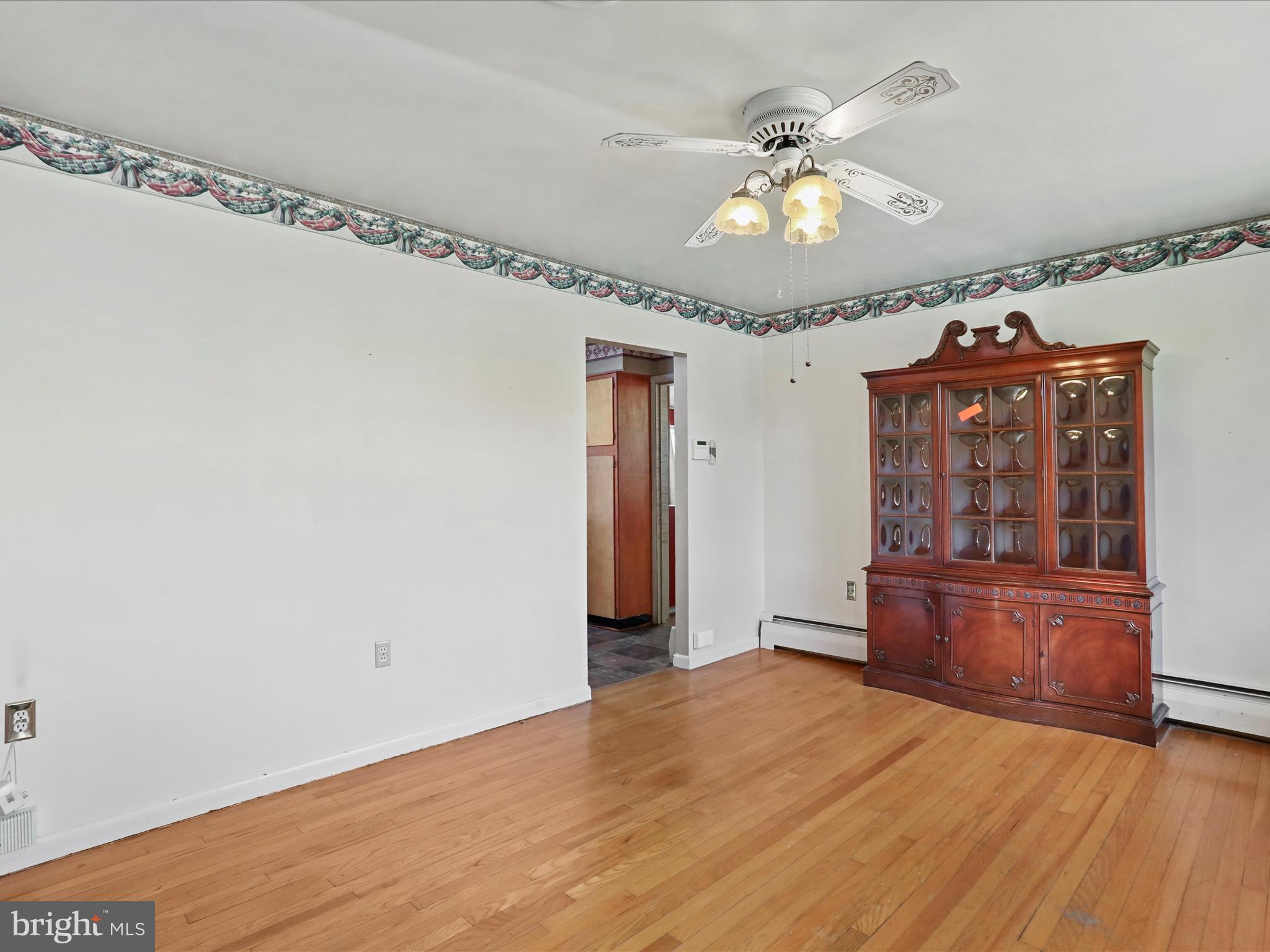 60 Grey Spring Avenue Bunker Hill, WV 25413 - Photo 7 of 35 wooden floor in an empty room with a window