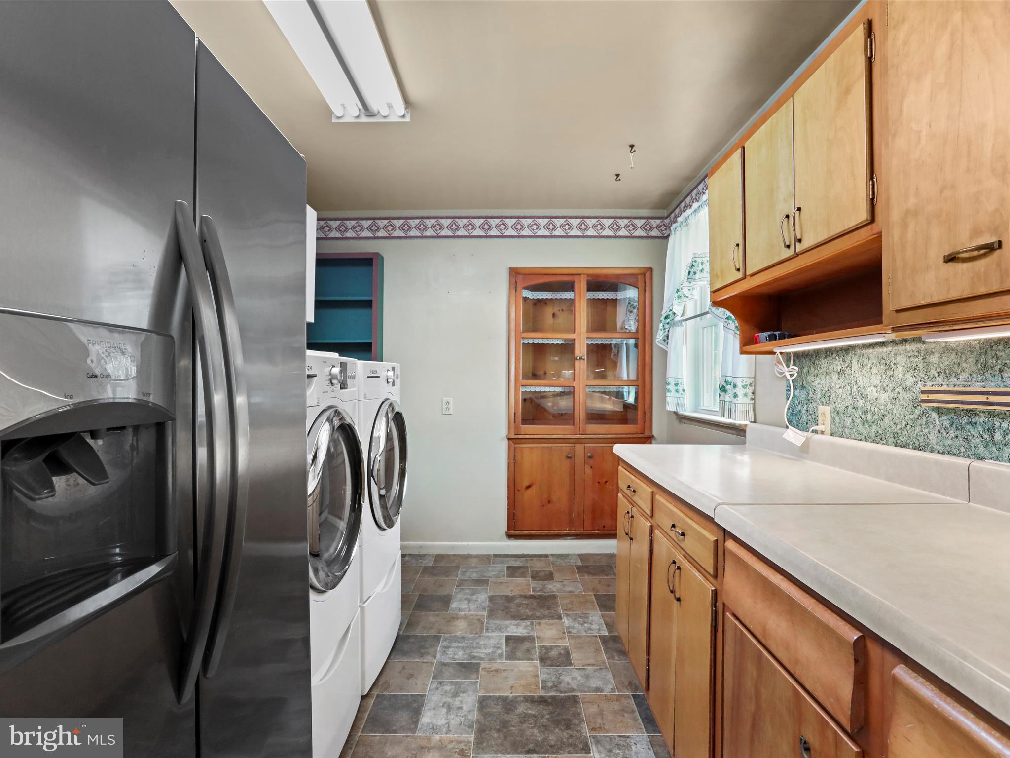 60 Grey Spring Avenue Bunker Hill, WV 25413 - Photo 9 of 35 a kitchen with stainless steel appliances granite countertop a sink a stove and a refrigerator