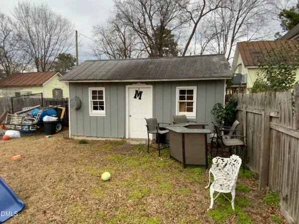 a backyard of a house with yard and seating space