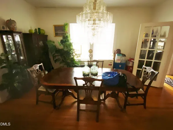 a view of a dining room with furniture and chandelier