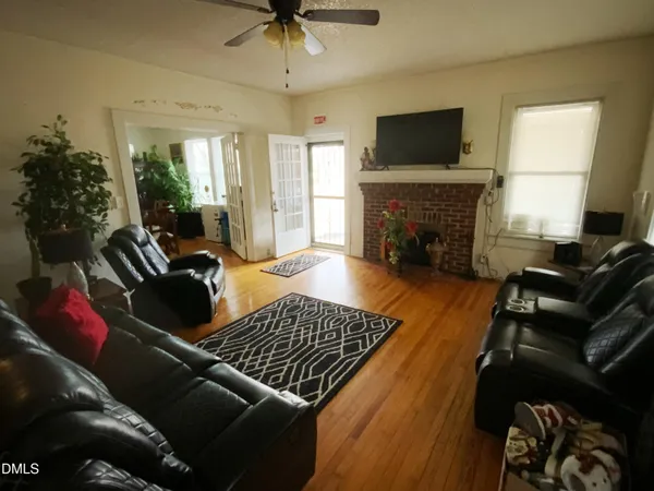 a living room with furniture fireplace and flat screen tv