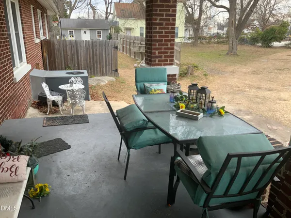 a view of a patio with iron fence