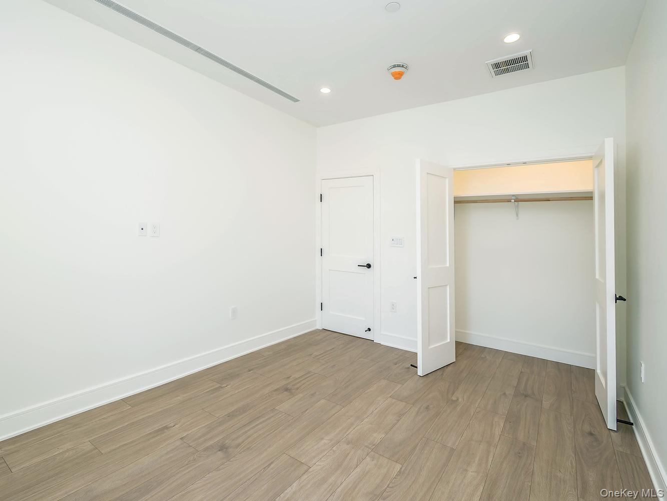 24 Lumber Road, Unit 2 Roslyn, NY 11576 - Photo 21 of 25 an empty room with wooden floor