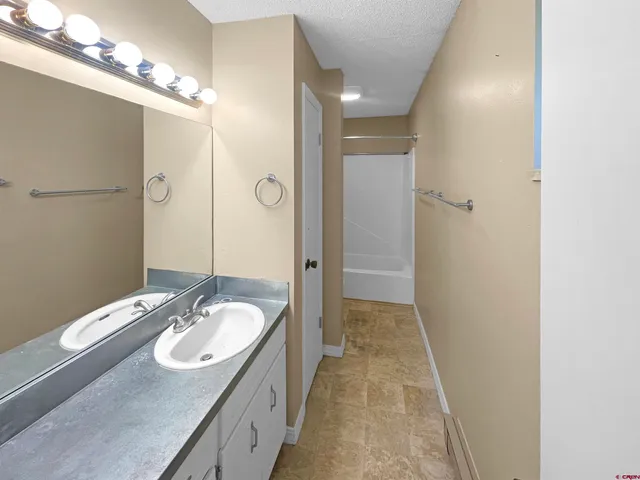 a bathroom with a sink double vanity and a mirror