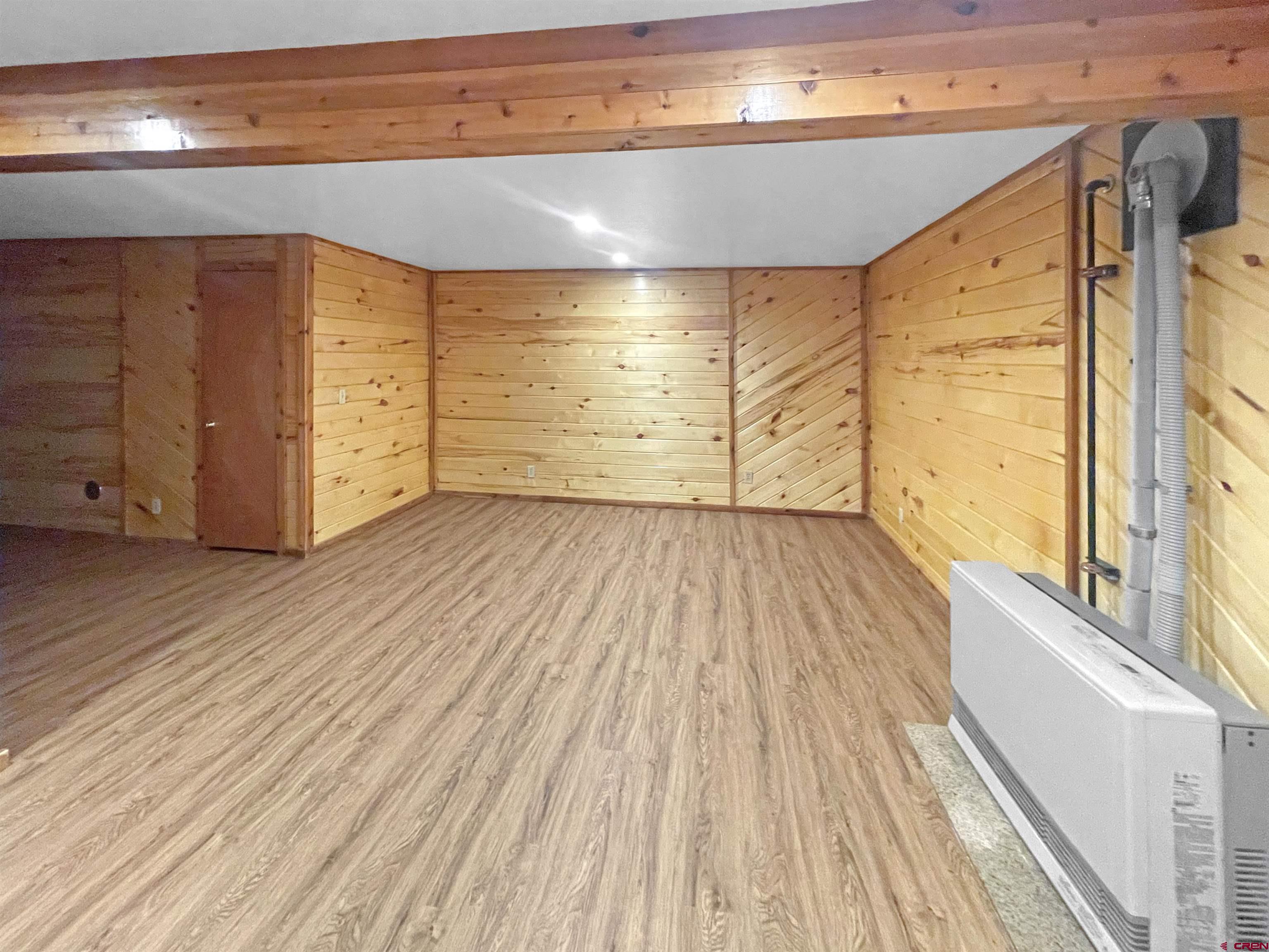 16 West 10th Street Cortez, CO 81321 - Photo 15 of 18 a view of a big room with wooden floor and windows