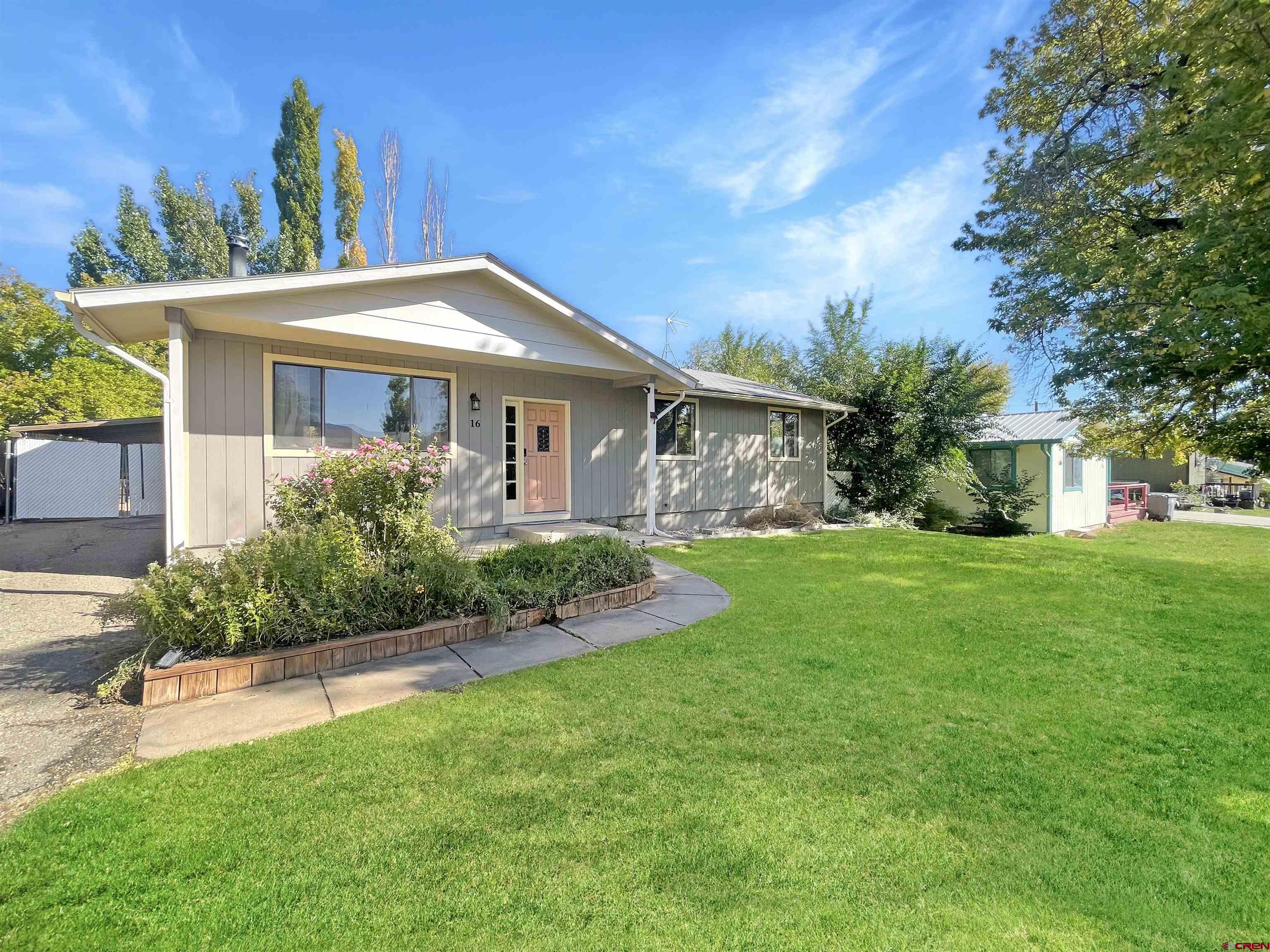 16 West 10th Street Cortez, CO 81321 - Photo 2 of 18 a front view of a house with a yard