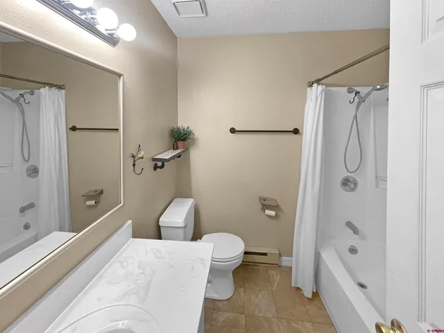 a en suite bathroom with a sink a toilet and shower