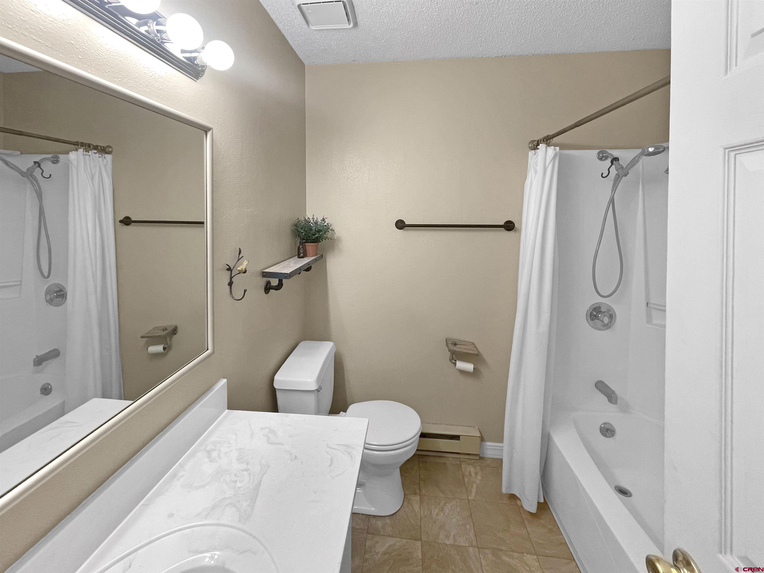 16 West 10th Street Cortez, CO 81321 - Photo 8 of 18 a en suite bathroom with a sink a toilet and shower