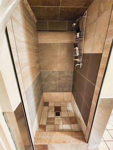 a bathroom with a glass door shower
