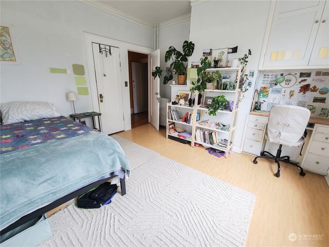 a bedroom with a bed and a chair in it