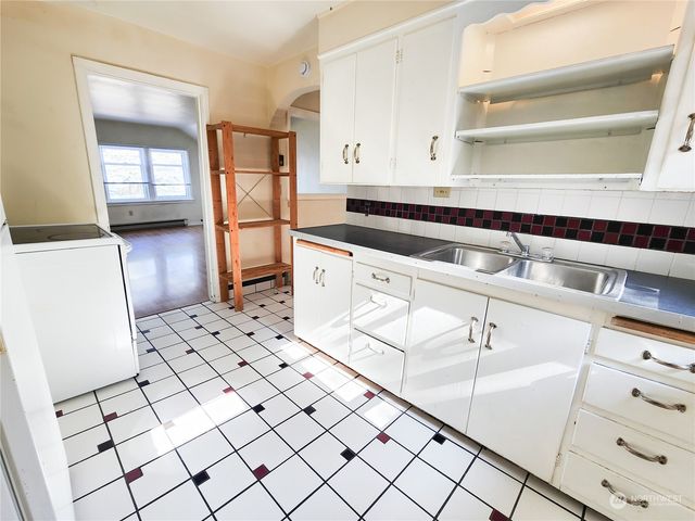 a kitchen with cabinets and window