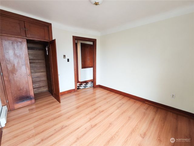 a view of a room with wooden floor and brick walls
