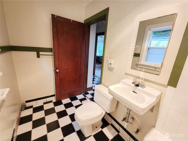 a bathroom with a sink toilet and mirror