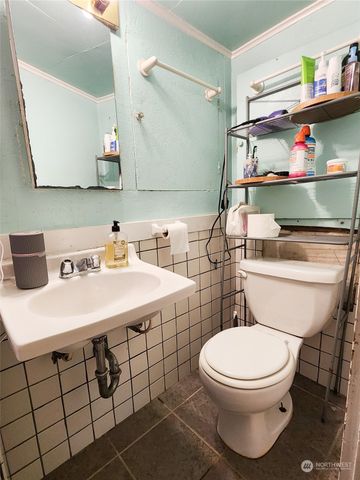 a bathroom with a sink a toilet and a mirror