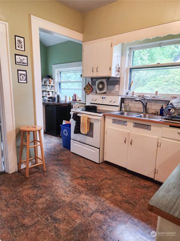 a kitchen with a sink cabinets and window