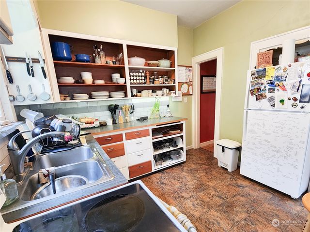 a kitchen with stainless steel appliances granite countertop a sink and cabinets