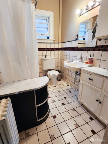 a bathroom with a sink toilet a mirror and vanity
